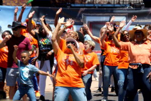 A group of people dance.