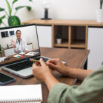 Patient speaking with a doctor during a telehealth medical consultation.