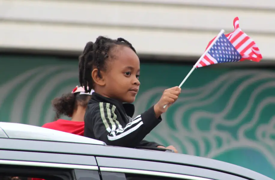 Spectators dressed in patriotic red, white and blue cheer as the 2026 Oceanside Independence Day Parade passes along Coast Highway on June 27. Photo by Samantha Nelson