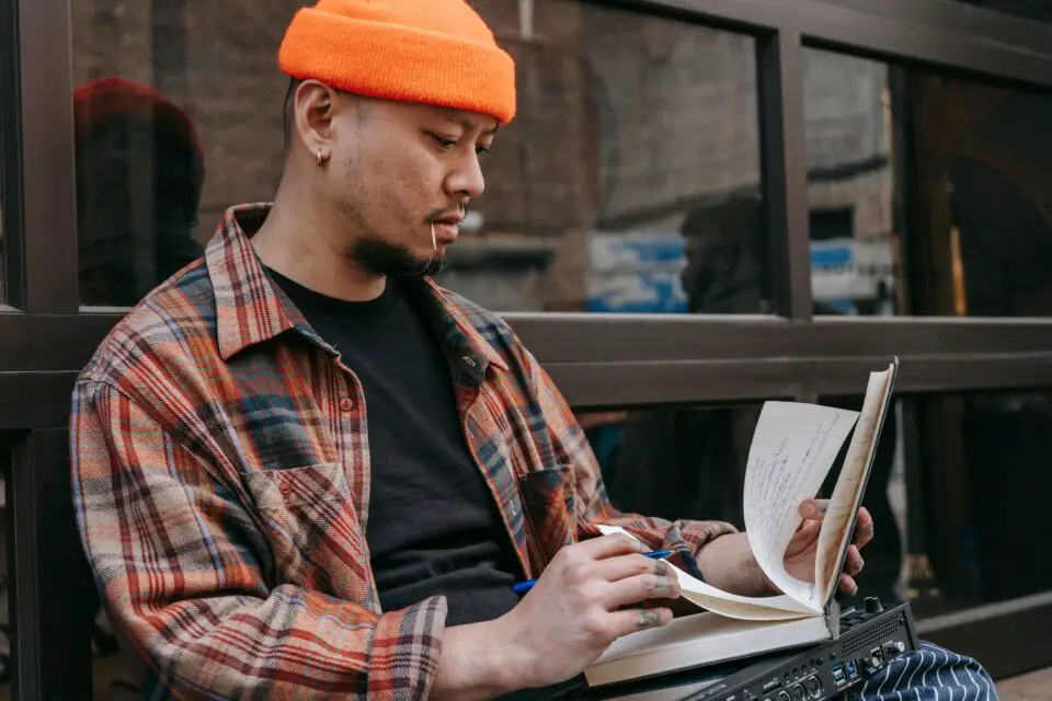 Student reviewing handwritten notes before beginning an academic writing assignment.