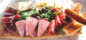 Tagliere di Formaggi e Salumi board featuring prosciutto, mortadella, salami, cheeses and toasted crostini paired with Ruffino Aqua di Venus Pinot Grigio. Photo by Rico Cassoni