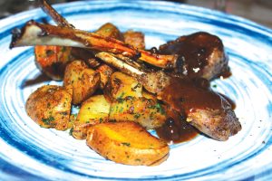 Lamb chop lollipops served with roasted potatoes and paired with Chianti Classico Gran Selezione Riserva Ducale Oro. Photo by Rico Cassoni