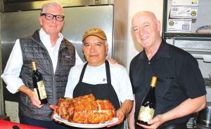 Breakthru Beverage's Scott Blackburn, from left, Vittorio's Chef Angel Gijon and Vittorio's proprietor Victor Magalhaes presenting Italian-style porchetta. Photo by Rico Cassoni