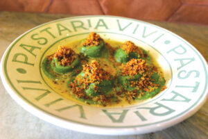 Spinach ravioli filled with ricotta cheese and Sicilian oregano served in a butter sauce and topped with panko served in a Rampini ceramic dish. Photo by Rico Cassoni