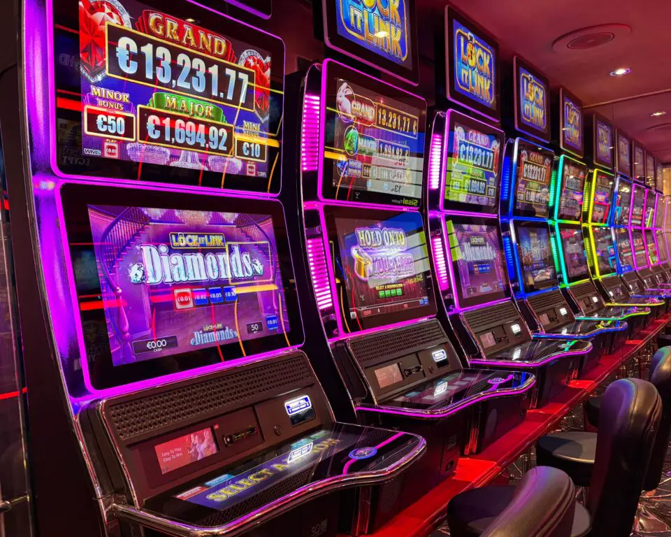 Row of colorful slot machines in a casino, illustrating online slot odds and RTP