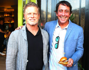 Queenstown owners Matt Baker, left, and PJ Lamont present a grass-fed organic slider at their new Del Mar location. Photo by Rico Cassoni