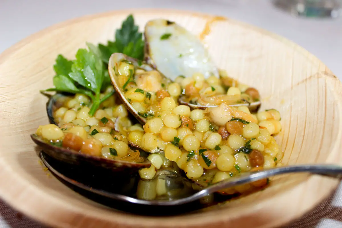 Fregola con Arselle, featuring fresh clams and Fregola Cous Cous. Photo by Rico Cassoni