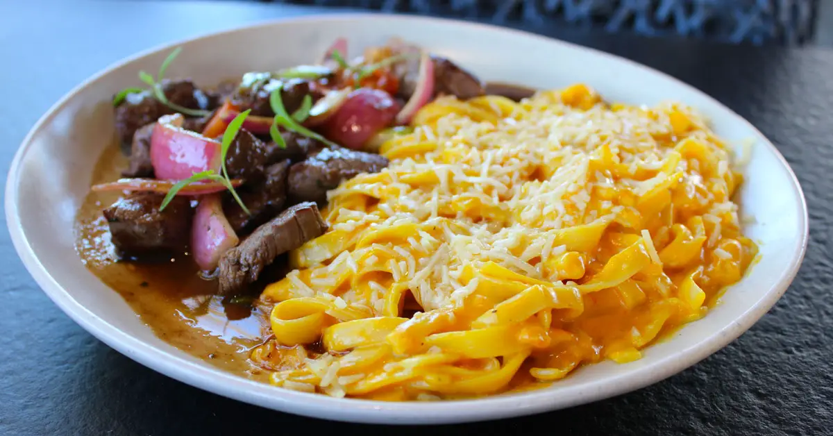 Fettucine a la Huancaina con Lomo Saltado. Tender wok-fired beef was served beside fettuccine coated in a rich, creamy Huancaina cheese sauce. Photo by Rico Cassoni