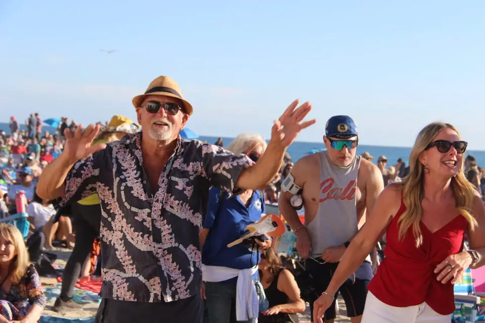 People dance on the beach