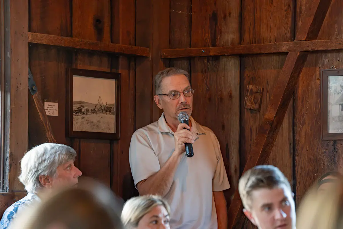 An Olivenhain resident speaks during a community town hall on July 22, raising concerns about traffic safety, speeding and planned development in the community. Photo by Tanya Perez