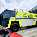 An Oshkosh Striker 1500 Global aircraft rescue and firefighting vehicle sits on the tarmac at McClellan-Palomar Airport in Carlsbad. Photo by Ryan Grothe