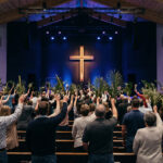 Modern church congregation worshipping in a sanctuary designed for high quality acoustics.