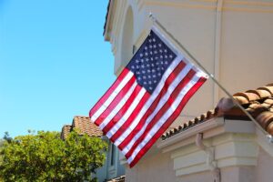 An American flag flying on the outside of a home