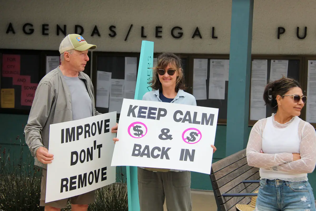 A group of demonstrators waved signs and chanted against the proposed overhaul of upgrades along Santa Fe Drive on June 24 outside of Encinitas City Hall. Photo by Summer Hu