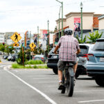 A cyclist rides an e-bike down Grand Avenue on July 1 in downtown Escondido. Photo by Samantha Nelson