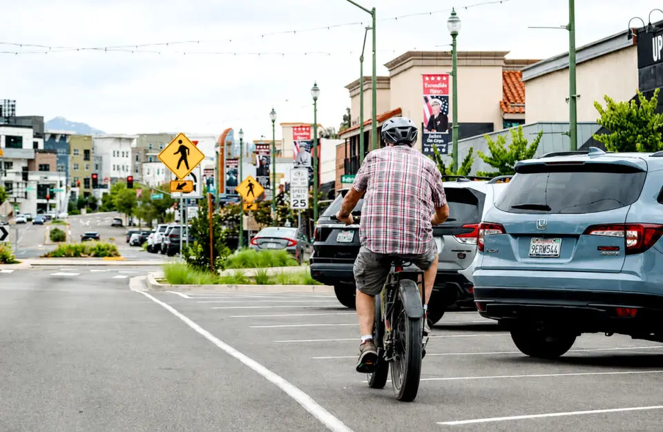 A cyclist rides an e-bike down Grand Avenue on July 1 in downtown Escondido. Photo by Samantha Nelson