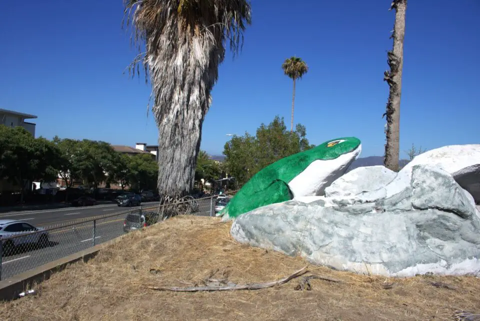 A rock painted to look like a green frog