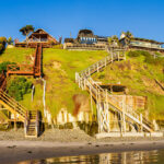 Clifftop homes overlook Grandview Beach in Encinitas. Photo by Billy McDonald