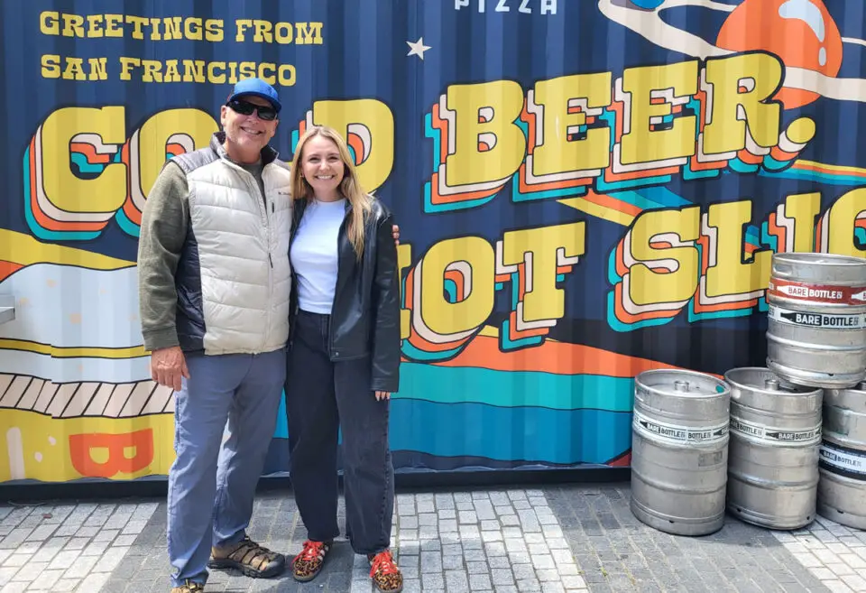 Cold beers and pizza at the Salesforce Park rooftop garden in San Francisco. Author Jeff Spanier, left, and Haley Spanier enjoy a stop during their Bay Area beer tour. Photo by Jeff Spanier