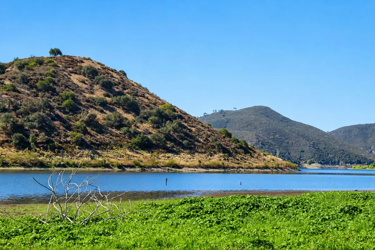 Lake Hodges, between Escondido, Rancho Bernardo and Rancho Santa Fe, has remained at lower water levels in recent years because of safety concerns related to Hodges Dam. The former, higher water line is visible along the surrounding hillsides. Photo by Samantha Nelson