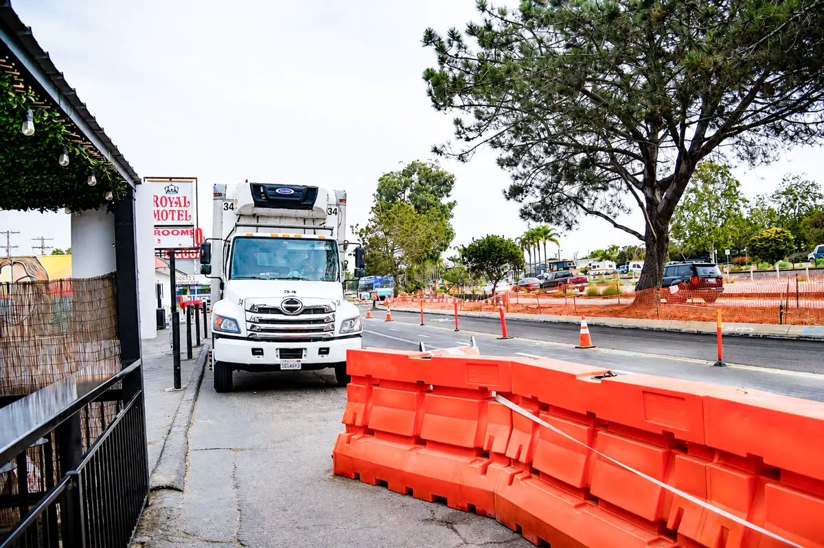 Orange barricades line North Coast Highway 101 in Leucadia as construction continues on the Leucadia Streetscape project, a multi-year effort to improve pedestrian and bicycle access while upgrading roadway and drainage infrastructure. Photo by Summer Hu