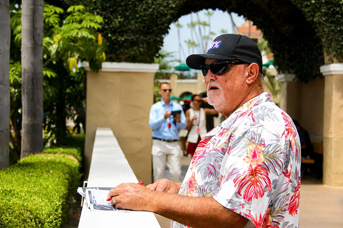Opening Day attendees review the race entries for the first day of the 2026 Del Mar summer racing season on July 17 at the Del Mar racetrack. Photo by Leo Place