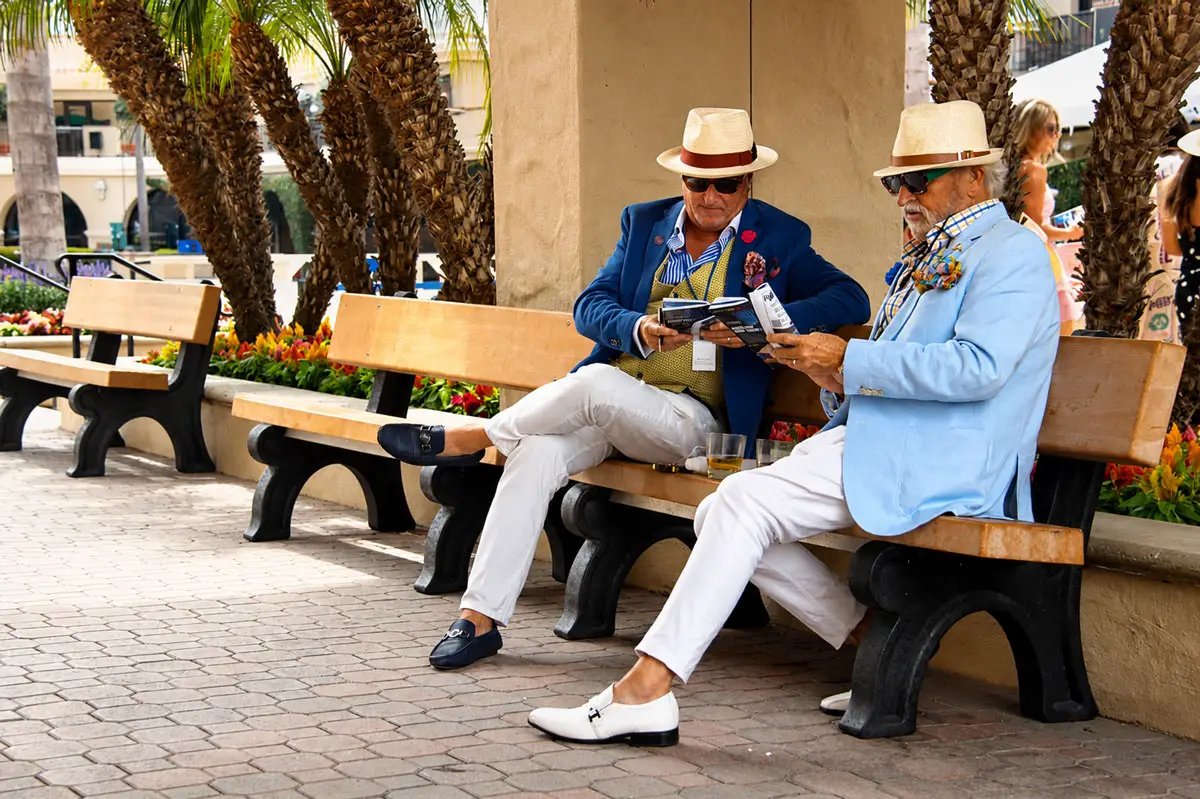 Opening Day attendees review the race entries for the first day of the 2026 Del Mar summer racing season on July 17 at the Del Mar racetrack. Photo by Leo Place