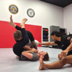 INSTRUCTOR NATE SALVA-CRUS guides students through a self-defense exercise at United Defense Tactical in San Marcos. Courtesy photo