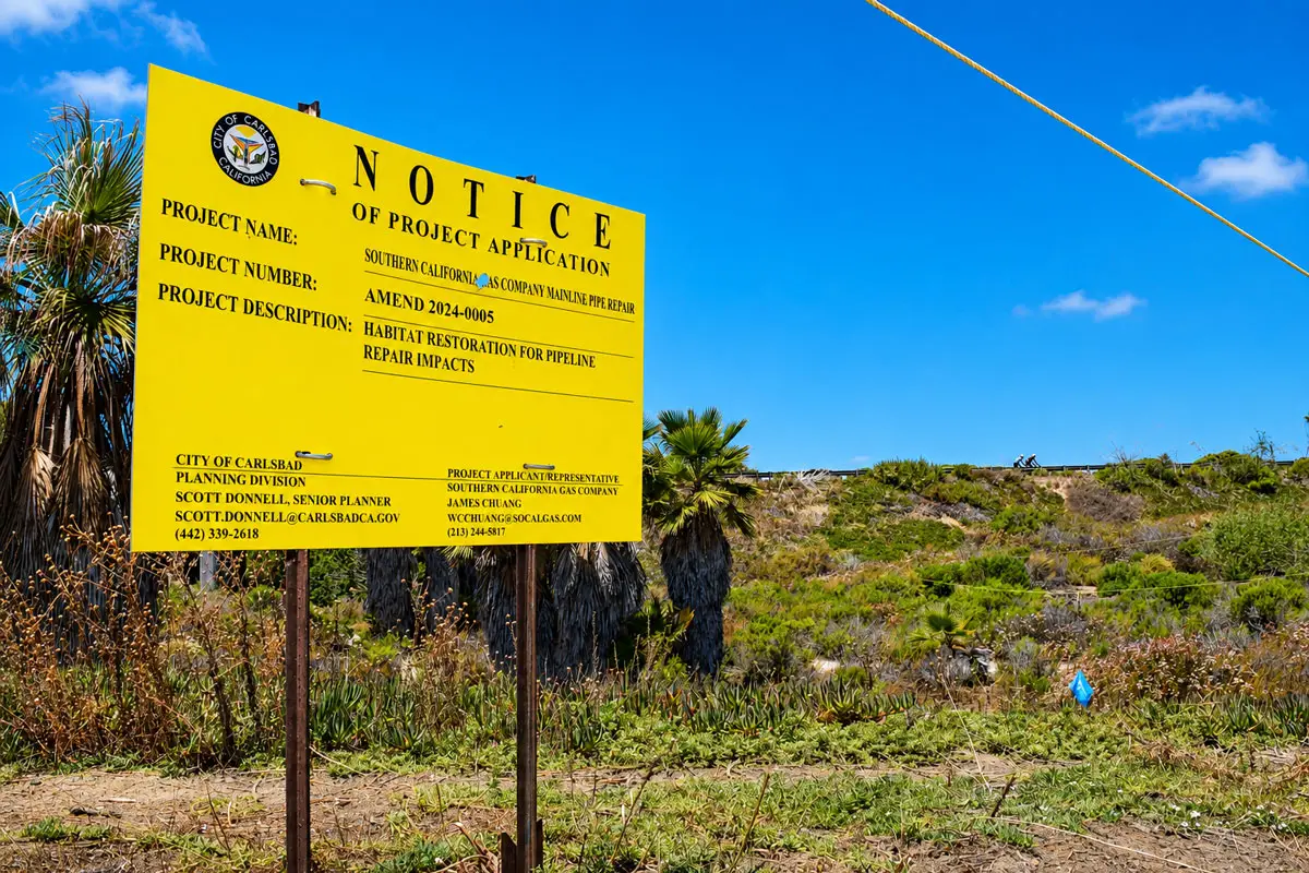 A development notice is posted at Planning Area F in Carlsbad's Ponto neighborhood. The vacant property is under review for the proposed PI Townhomes development. Photo by Summer Hu