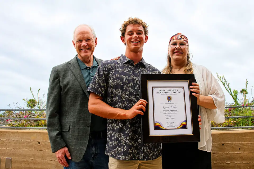 Quade Kelley, winner of The Coast News Teen Writing Contest, Encinitas Mayor Bruce Ehlers and contest sponsor Melissa Huk of Ms. Oceanside Real Estate smile for a photo on July 9 at the Encinitas Library. Photo by Jordan P. Ingram