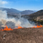 Firefighters work along the perimeter of the Rainbow 3 Fire near Fallbrook. Screenshot/Fox 5