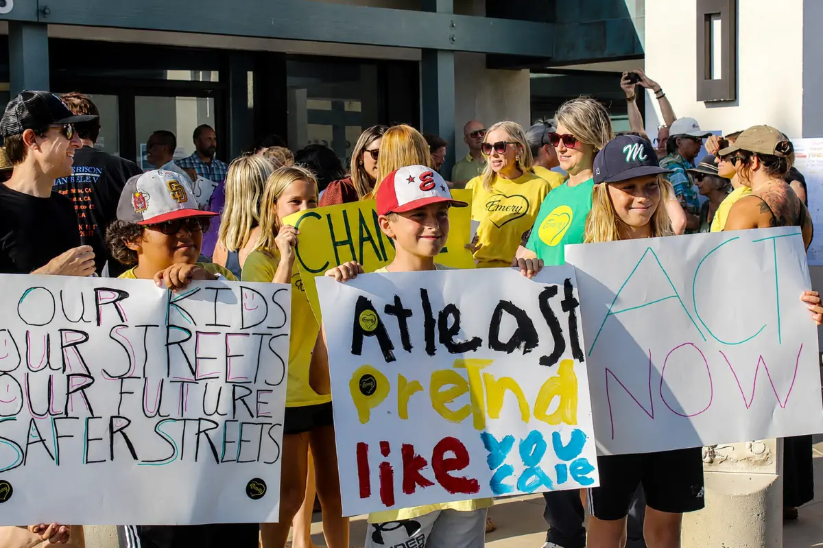 Dozens of residents gather outside Encinitas City Hall during a July 21 rally held by Safe Streets Encinitas urging city leaders to take action to improve street safety. Photo by Samantha Nelson