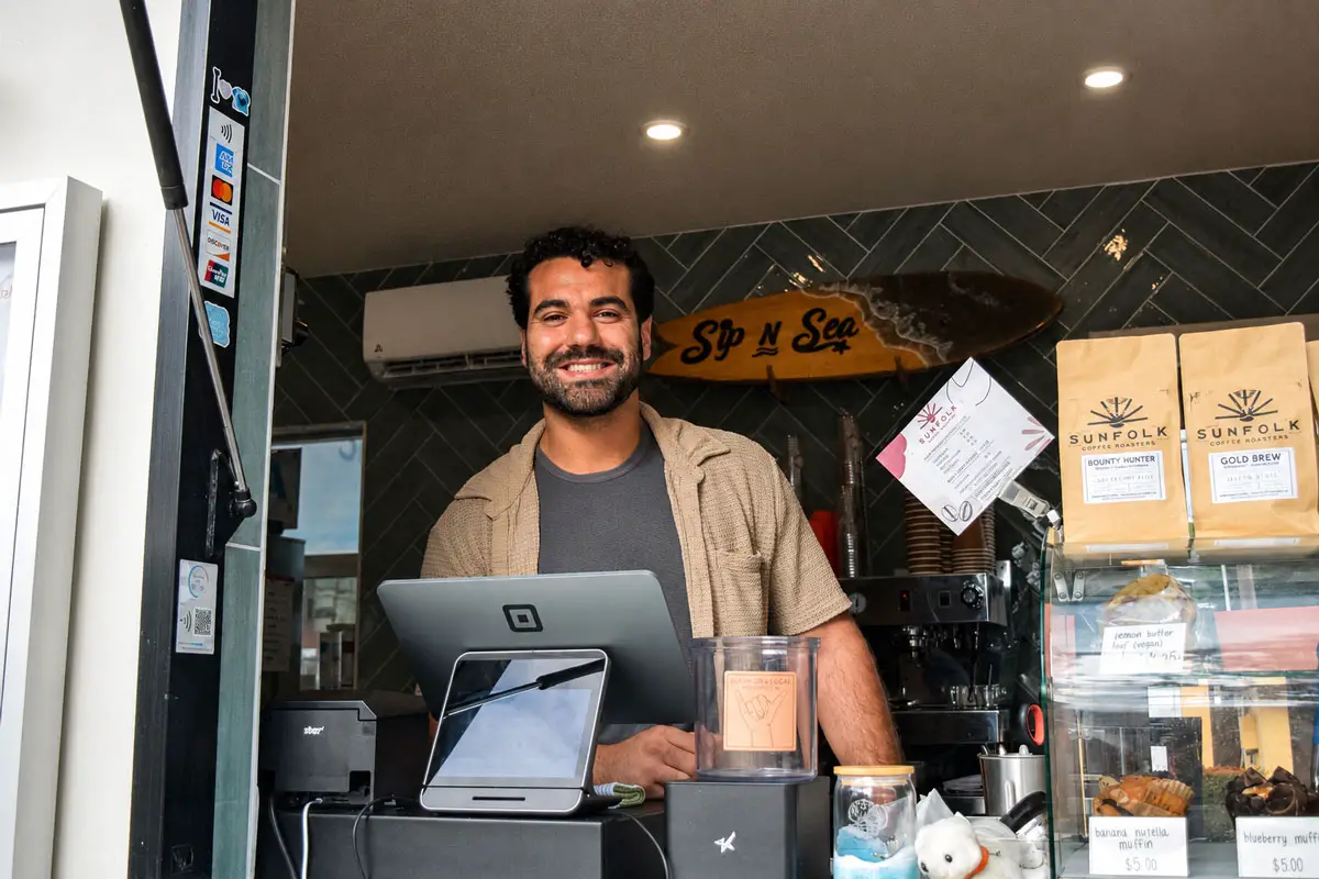 Sip-N-Sea owner Giuseppe Georgees stands at the walk-up window of his Leucadia business along North Coast Highway 101, where ongoing construction has affected customer access during the Leucadia Streetscape project. Photo by Summer Hu