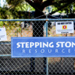 A sign posted on a chain link fence at Stepping Stone Resources care facility in Fallbrook.