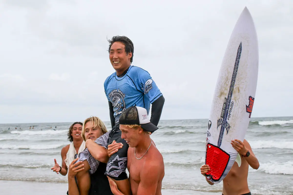 Encinitas native Kyan Yang is carried from the surf after winning the Virginia Beach Pro on Aug. 29. Photo by Andrew Nichols