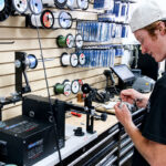 Merrick Meyers spools a fishing reel at North County Bait & Tackle, his family’s new shop in Encinitas. Photo by Cameron Adams