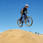 A young rider catches air off a dirt jump at Bradley Bike Park in San Marcos. File photo/Leo Place