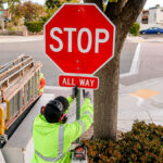 City crews install new all-way stop signs at the intersection of Grand Avenue and Madison Street in Carlsbad in April 2026. Courtesy photo/City of Carlsbad