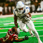 Carlsbad and Mission Hills players battle during a 2025 matchup in San Marcos. The Lancers defeated the Grizzlies 31-17. Photo by Julian Liner
