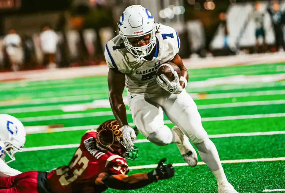 Carlsbad and Mission Hills players battle during a 2025 matchup in San Marcos. The Lancers defeated the Grizzlies 31-17. Photo by Julian Liner