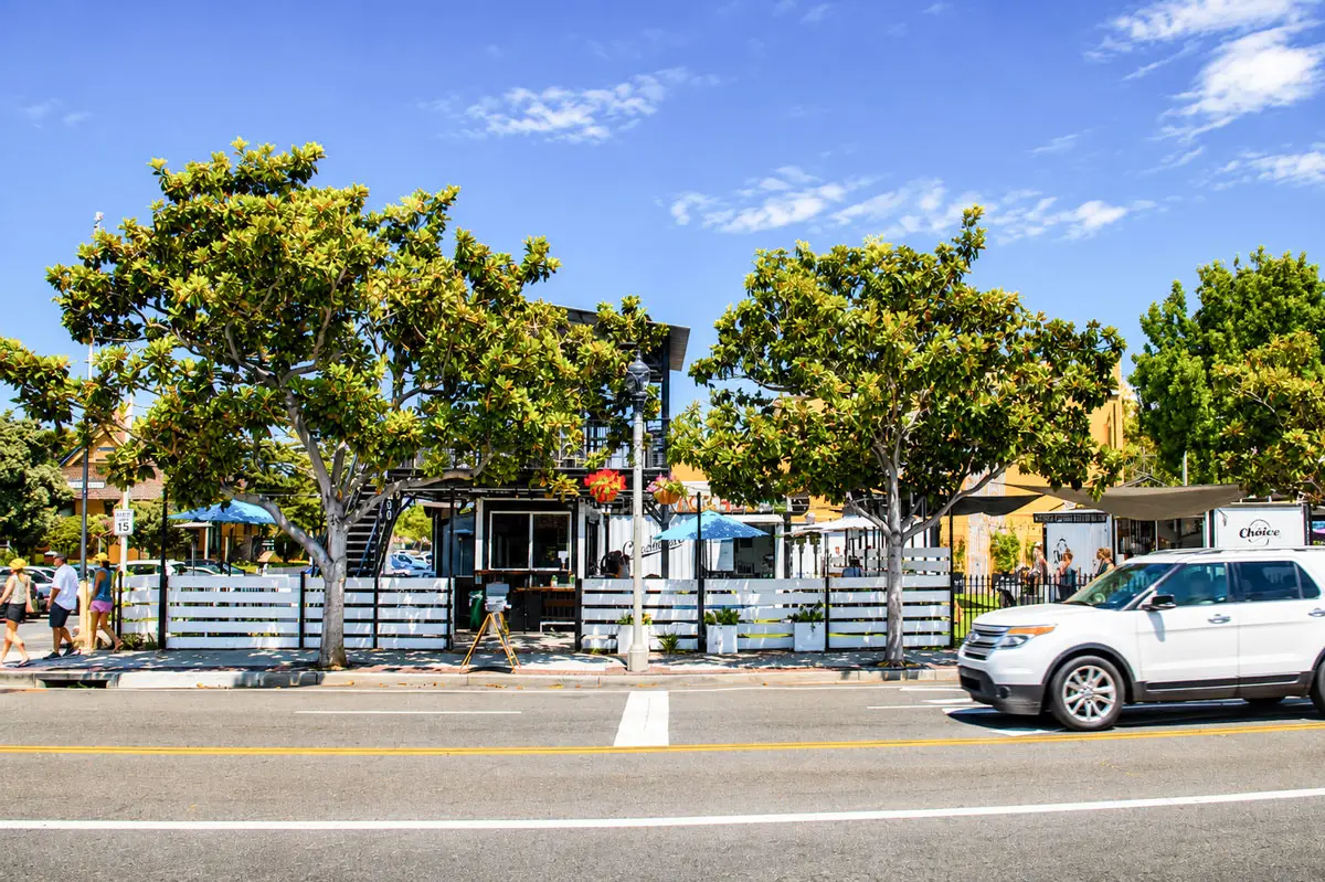 The proposed Carlsbad Village Square development site, seen from across Carlsbad Village Drive, currently houses two restaurants operating out of shipping containers at the corner of State Street. Photo by Cameron Adams