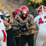 A Cathedral Catholic ball carrier fights for yardage during the Dons’ 38-24 season-opening loss to Orange Lutheran on Friday at Manchester Stadium. Photo by Isaac Angel