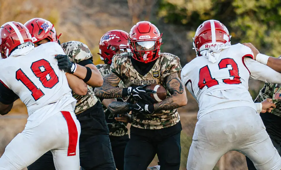 A Cathedral Catholic ball carrier fights for yardage during the Dons’ 38-24 season-opening loss to Orange Lutheran on Friday at Manchester Stadium. Photo by Isaac Angel