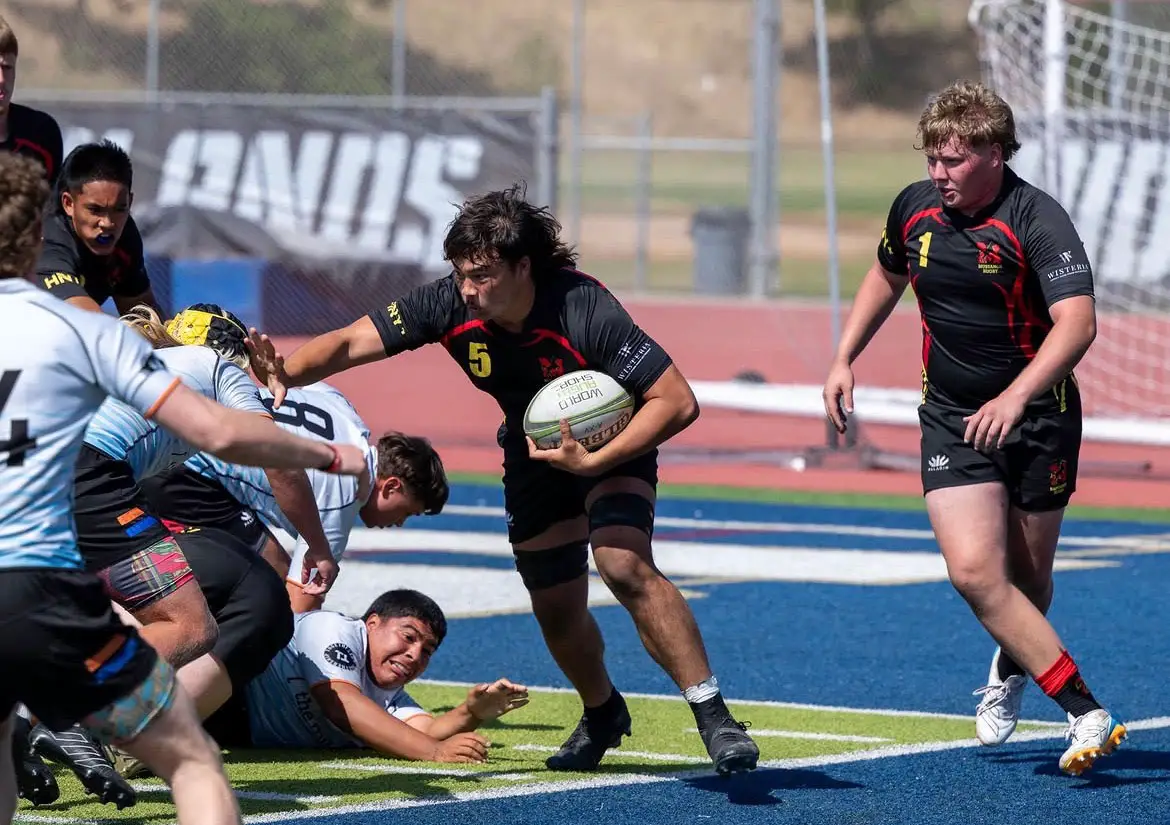 Torrey Pines High senior David “Duck” Choy carries the ball near a pile of players during a rugby match. Choy was among 28 players selected for the USA Rugby U18 Boys National Team’s three-week tour of South America this summer. Courtesy photo