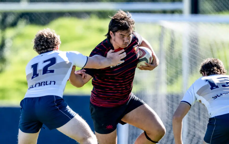 Torrey Pines High senior David “Duck” Choy carries the ball during a rugby match. Courtesy photo