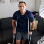 Encinitas attorney Mike Eisenberg uses crutches at his home after being struck and injured by a hit-and-run driver Aug. 16 on Glen Arbor Drive. Photo by Jordan P. Ingram