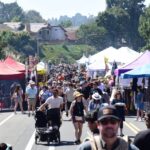 Crowds visit local business and artisan booths at the Encinitas Oktoberfest & Artisan Faire
