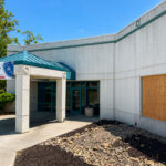 A boarded-up window is visible at the Encinitas post office on Garden View Road after a vehicle crashed into the building Aug. 1. The post office remains open. Photo by Cameron Adams