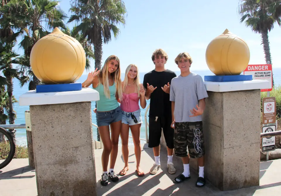 Encinitas surfers (L-R) Victoria Duprat, Maddie Stanton, Jett Maughan, and Dane Libby will compete in the International Surfing Association’s World Junior Surfing Championships. Photo by Cameron Adams