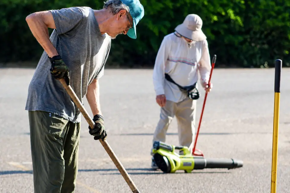 Fallbrook residents Franz Pusch and Mike Crowell fill potholes along Sumac Road early one Saturday morning this summer. Photo by Samantha Nelson